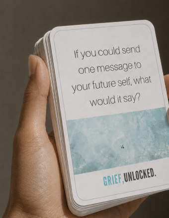 A deck of Grief, Unlocked reflection cards held in a hand