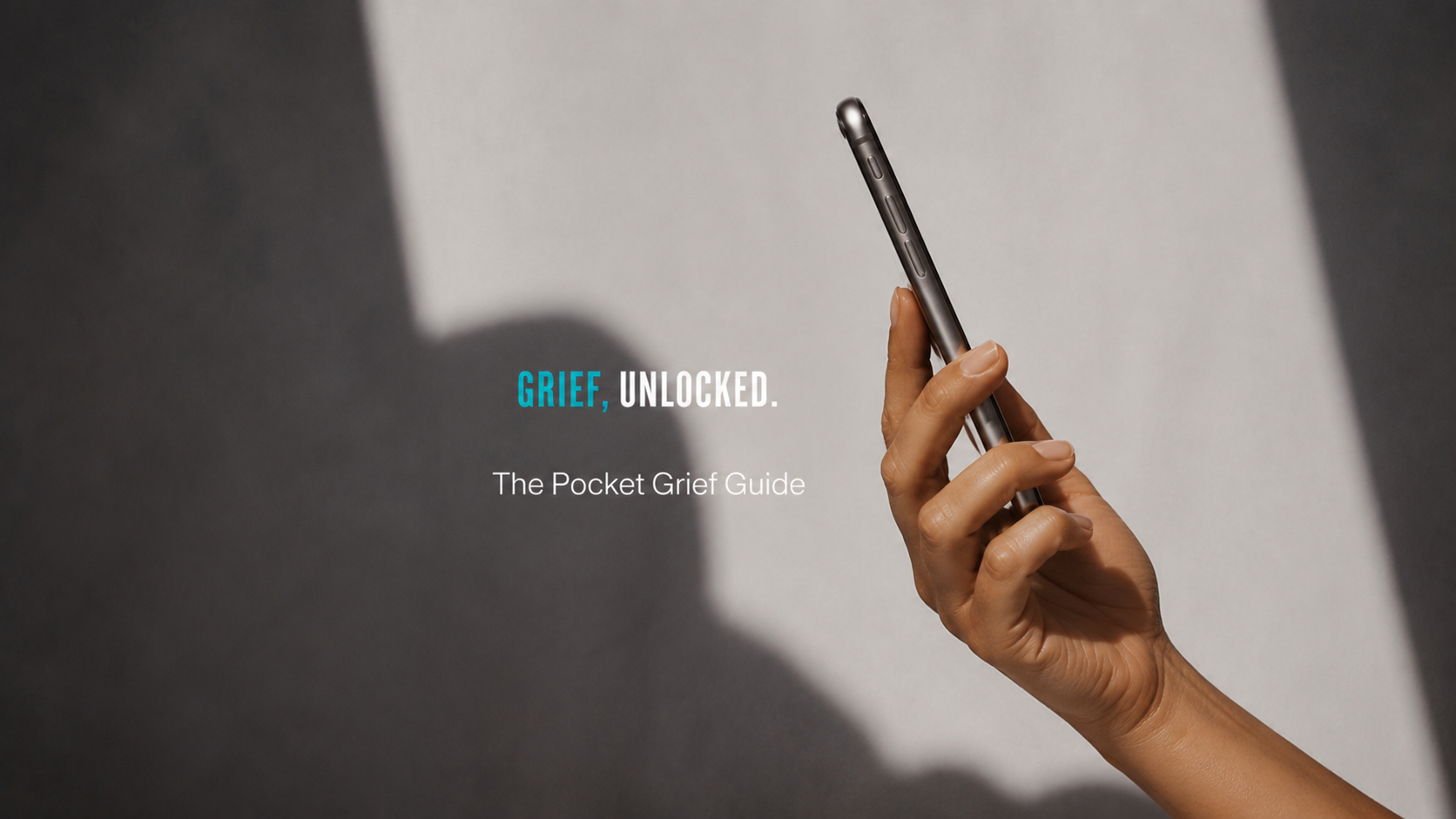 A hand holding a phone with The Pocket Grief Guide open